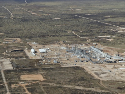 An aerial view of a natural gas refinery emitting methane emissions